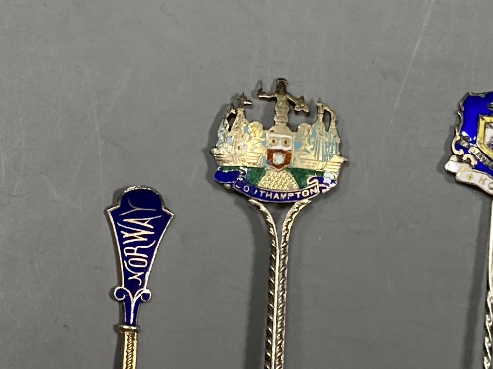 Six 20th century assorted silver and enamel souvenir spoons, gross 81 grams and five similar white metal and enamel spoons,